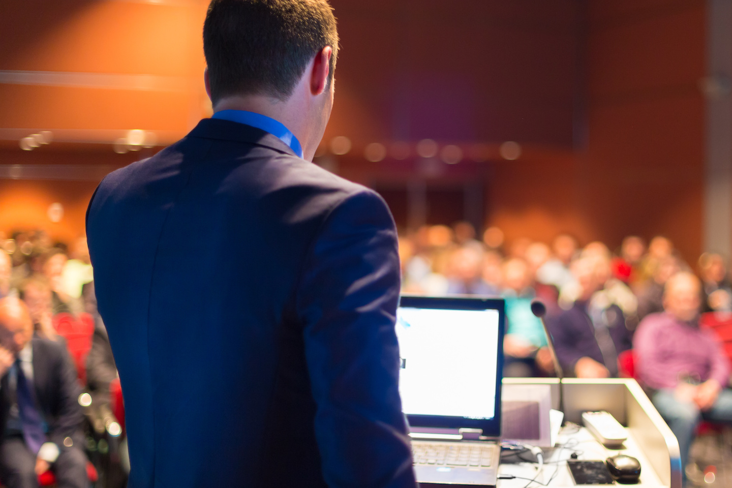 Corey Quinn speaking at a conference